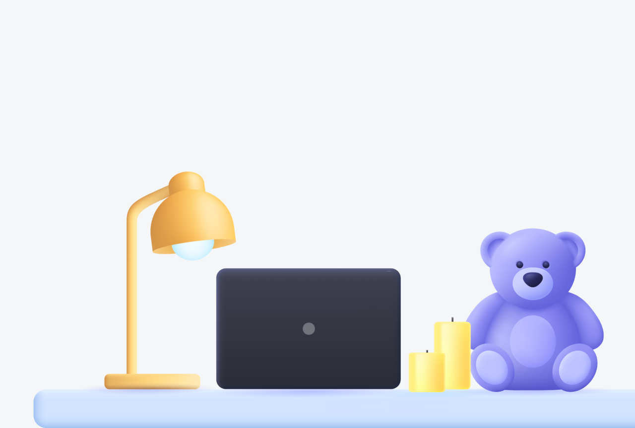 Computer on desk with a light and stuffed bear