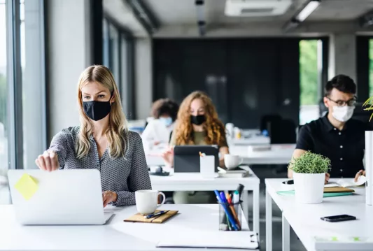 Employees wearing masks in the workplace while working