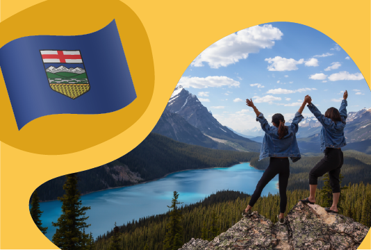 Alberta's flag next to a person celebrating on a mountain peak.